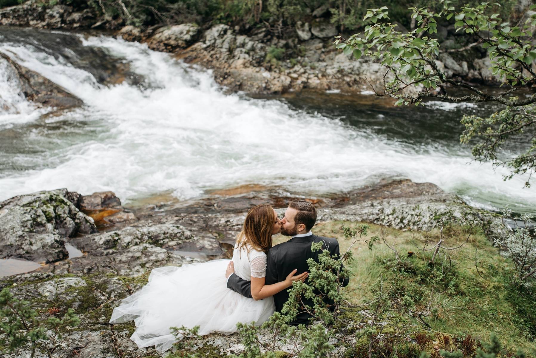 Newly Married Couple Kissing by River in Big Sky Montana