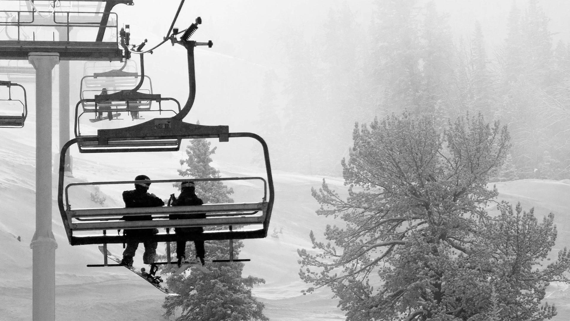 Two People on Ski Chair Lift at Big Sky While Its Snowing